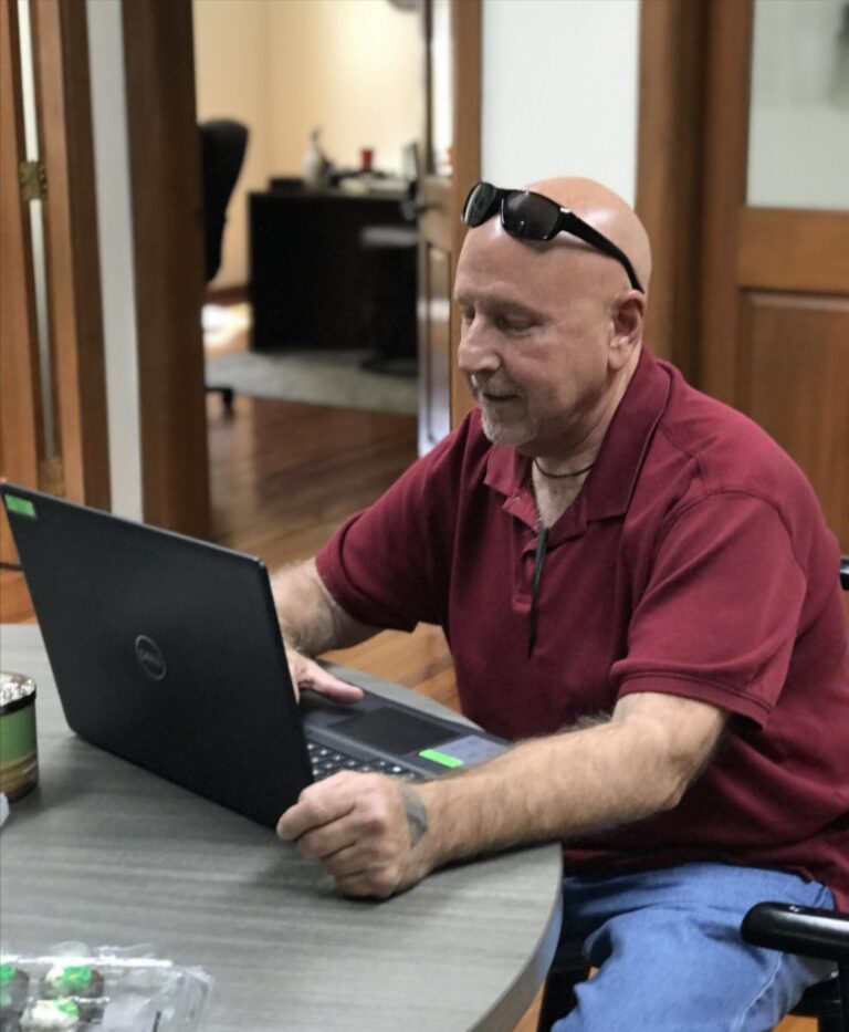 Eugene Cossich using a laptop computer