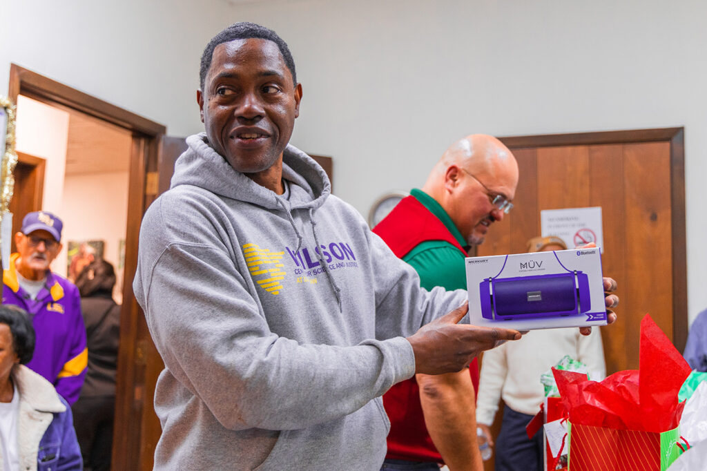 Parole Project client holding his Christmas gift