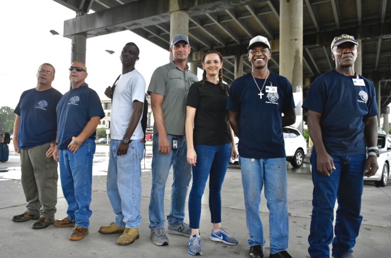 Surplus property warehouse manager Michael Gachot with his crew of formerly incarcerated Parole Project clients