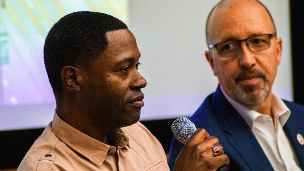 Attendee of Visiting Room Project event holding a microphone