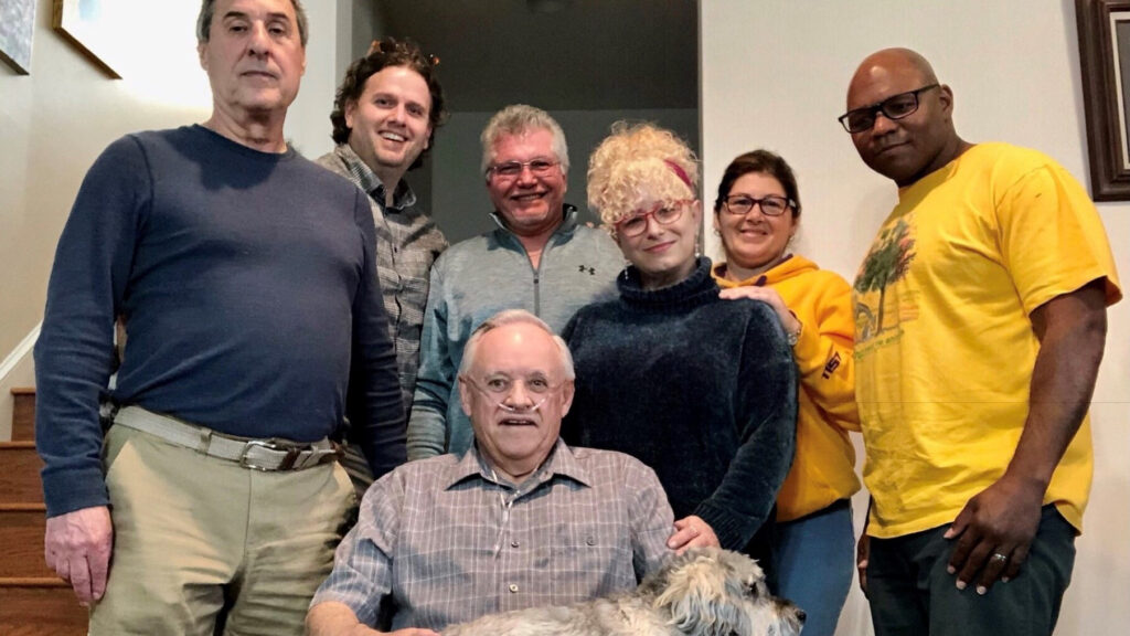 Photo of longtime volunteer Bill Auten with the staff of Parole Project