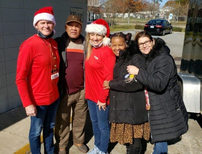 Members of the Healing Place Church's Outreach Program and Parole Project distributing gifts at Joseph Homes