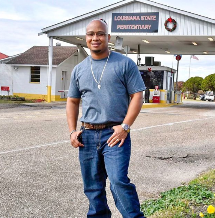 Photograph of Parole Project client, Keith in front of Angola gates