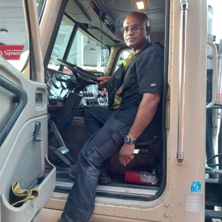 Parole Project client Joseph Papillion sits proudly in the cab of a big rig tractor as he reflects on the accomplishment of a major goal.